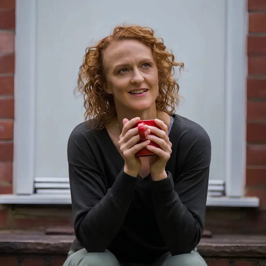 Woman smiling drinking coffee